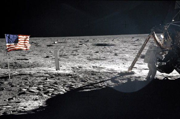 Armstrong stepping onto the moon's surface 